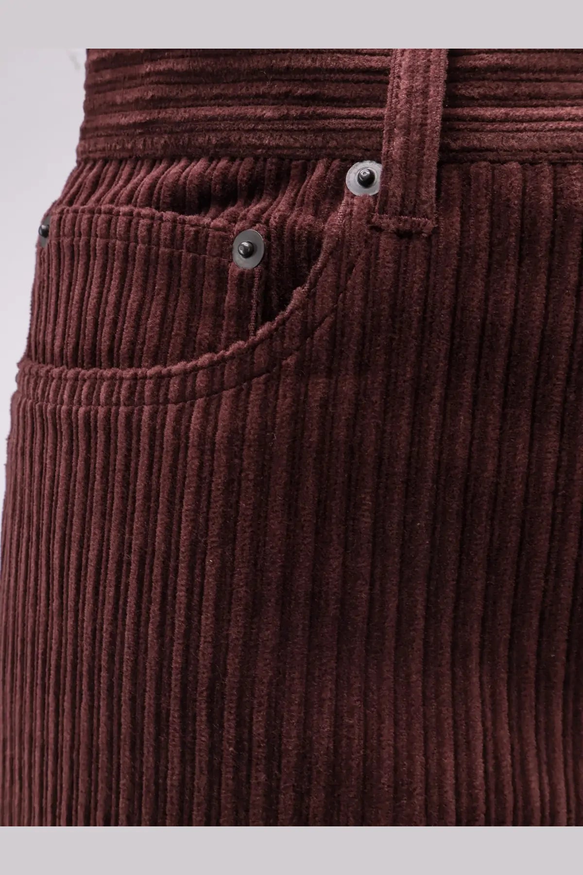 Tonywack unisex red corduroy trousers with vertical ribbed texture and silver toned button fastenings