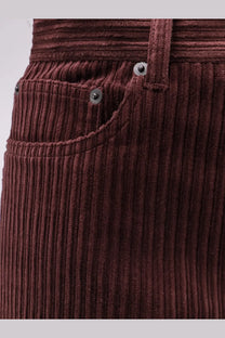 Tonywack unisex red corduroy trousers with vertical ribbed texture and silver toned button fastenings