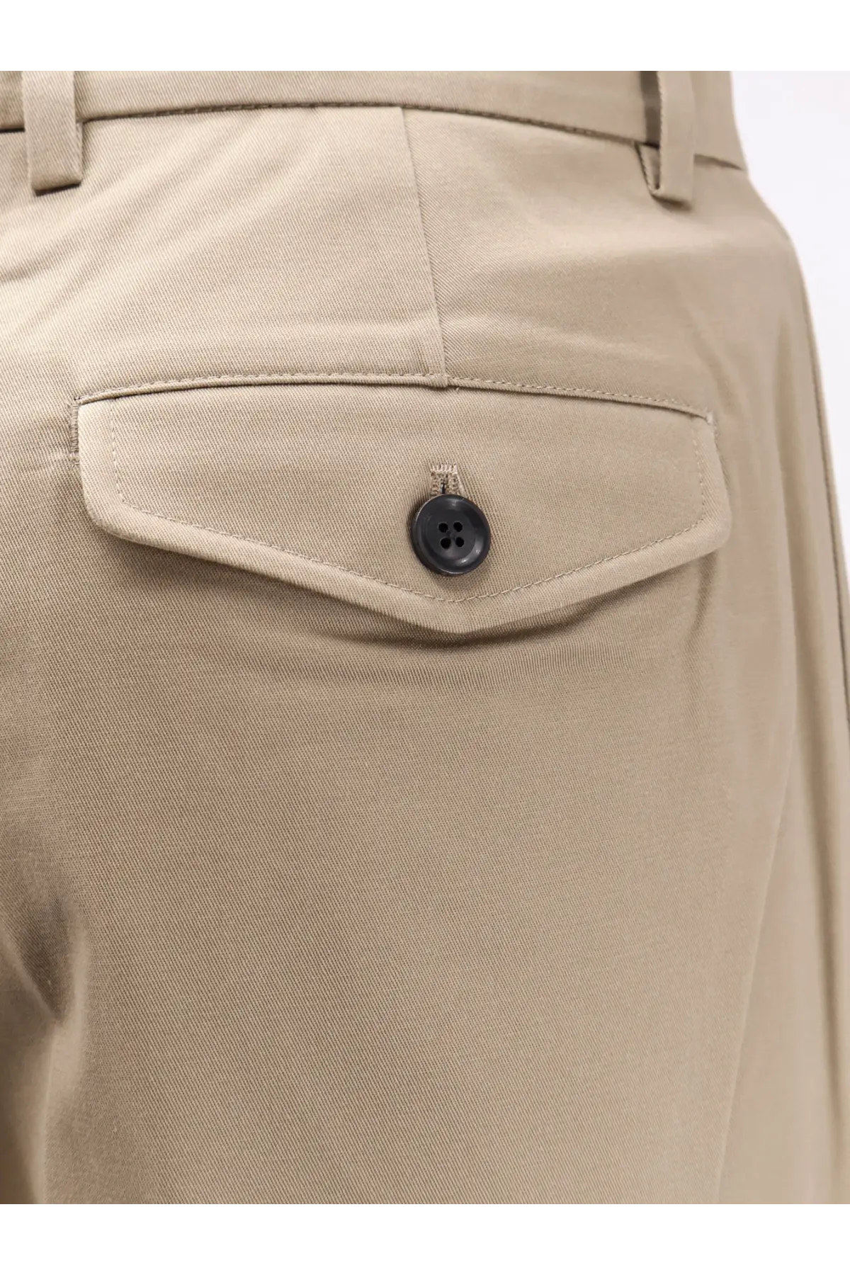 Beige cotton chino pants with dark button on back pocket shown from the back by Tonywack unisex trousers