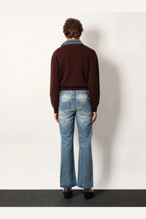 Brown knit sweater with striped collar worn over blue denim flared leg unisex jeans by tonywack