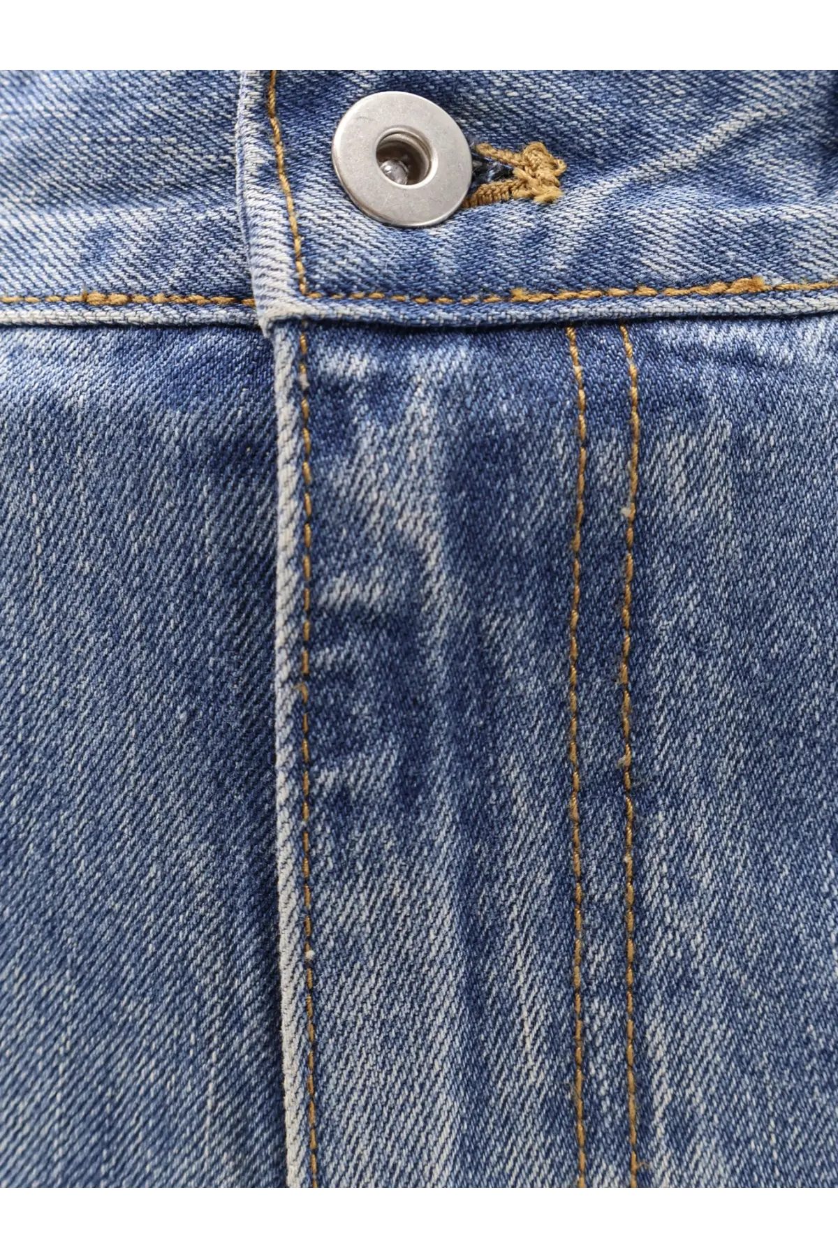 Blue denim fabric with tan stitching and silver button detail on tonywack unisex flared leg jeans