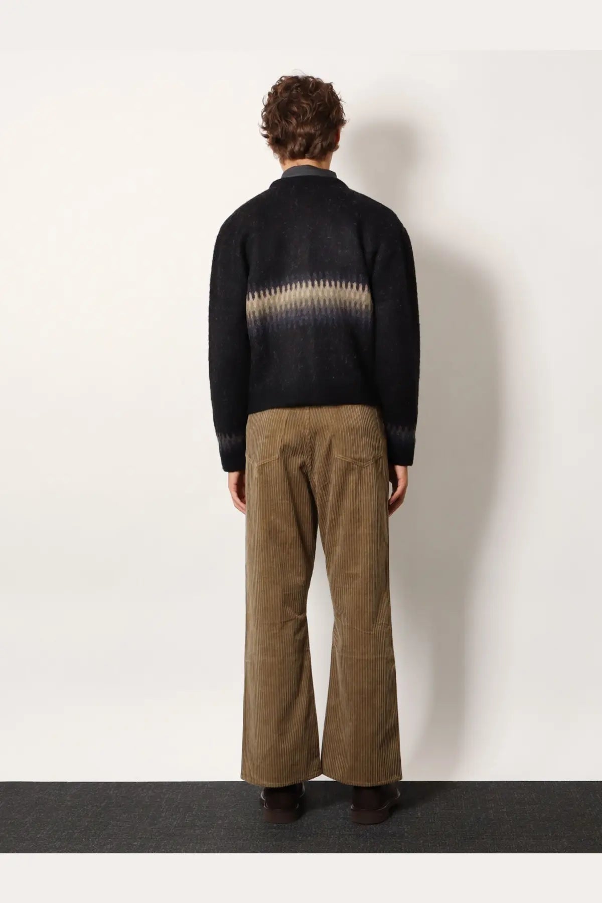 Back view of tonywack unisex jacquard alpaca cardigan black knit sweater with beige dark gradient and ribbed cuffs