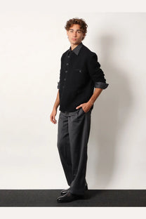 Black button-up jacket with rolled sleeves paired with dark gray pinstripe wool blend trousers from Tonywack unisex collection