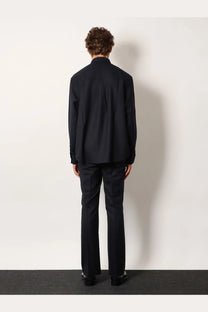 Black tailored suit with structured jacket and matching trousers in wool blend fabric for formal wear
