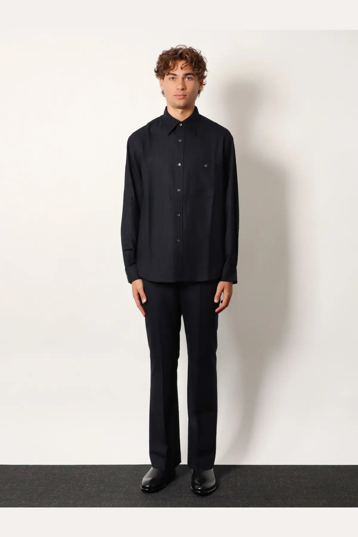 Black long-sleeved wool blend button-down shirt with subtle chest pocket and minimalist design by tonywack