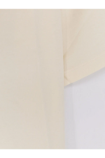 Cream-colored sleeve of tonywack women’s cotton blend shirt with soft texture and neatly stitched hem in yellow