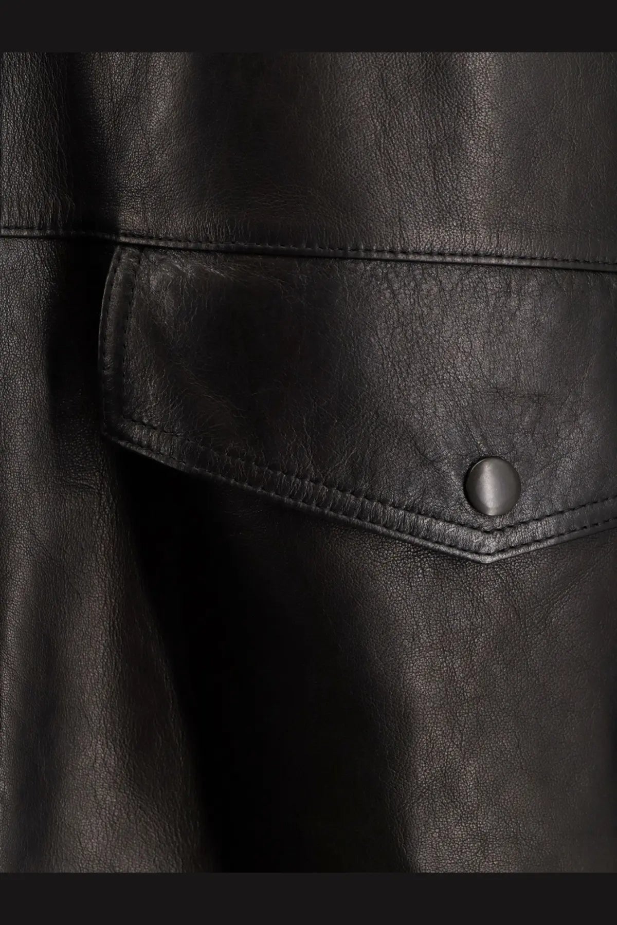 Tonywack women’s long padded black leather jacket with flap pocket secured by matching button in unisex style