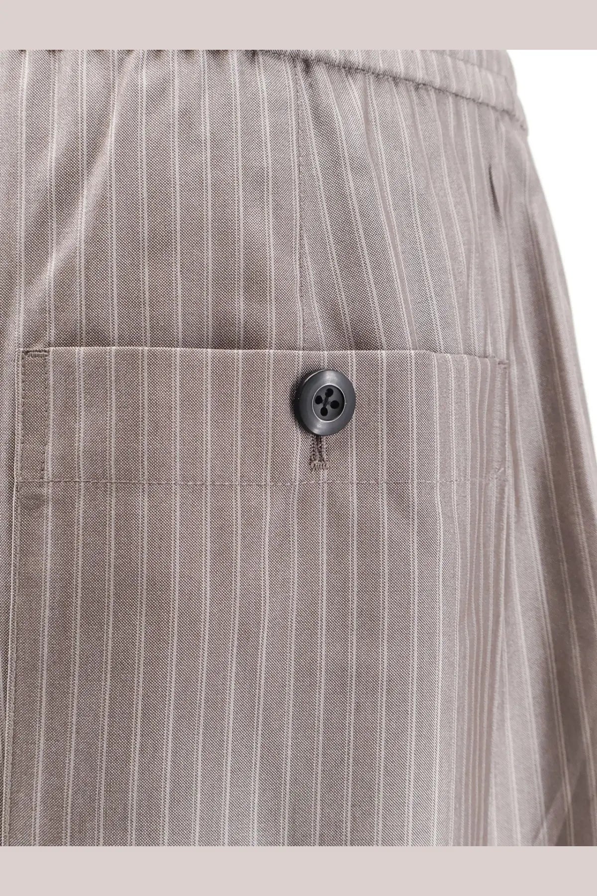 Tonywack women’s grey polyester and wool blend trousers with subtle texture and dark gray button detail on front pocket