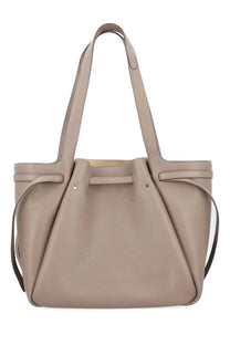 Tory Burch women’s beige leather tote bag Romy with drawstring closure and structured slouched silhouette