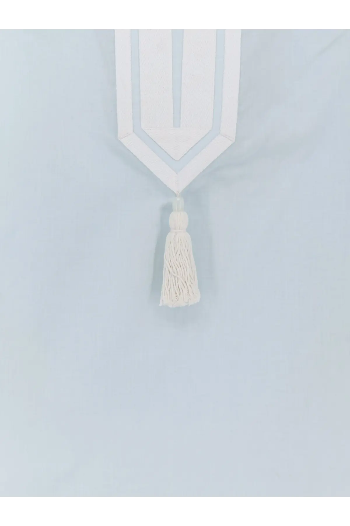 White geometric curtain tie-back with matching tassel complementing tory burch cotton blue women’s tunic shirt