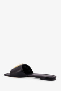 Black leather slide sandal with gold-tone Tory Burch logo emblem on the strap for women