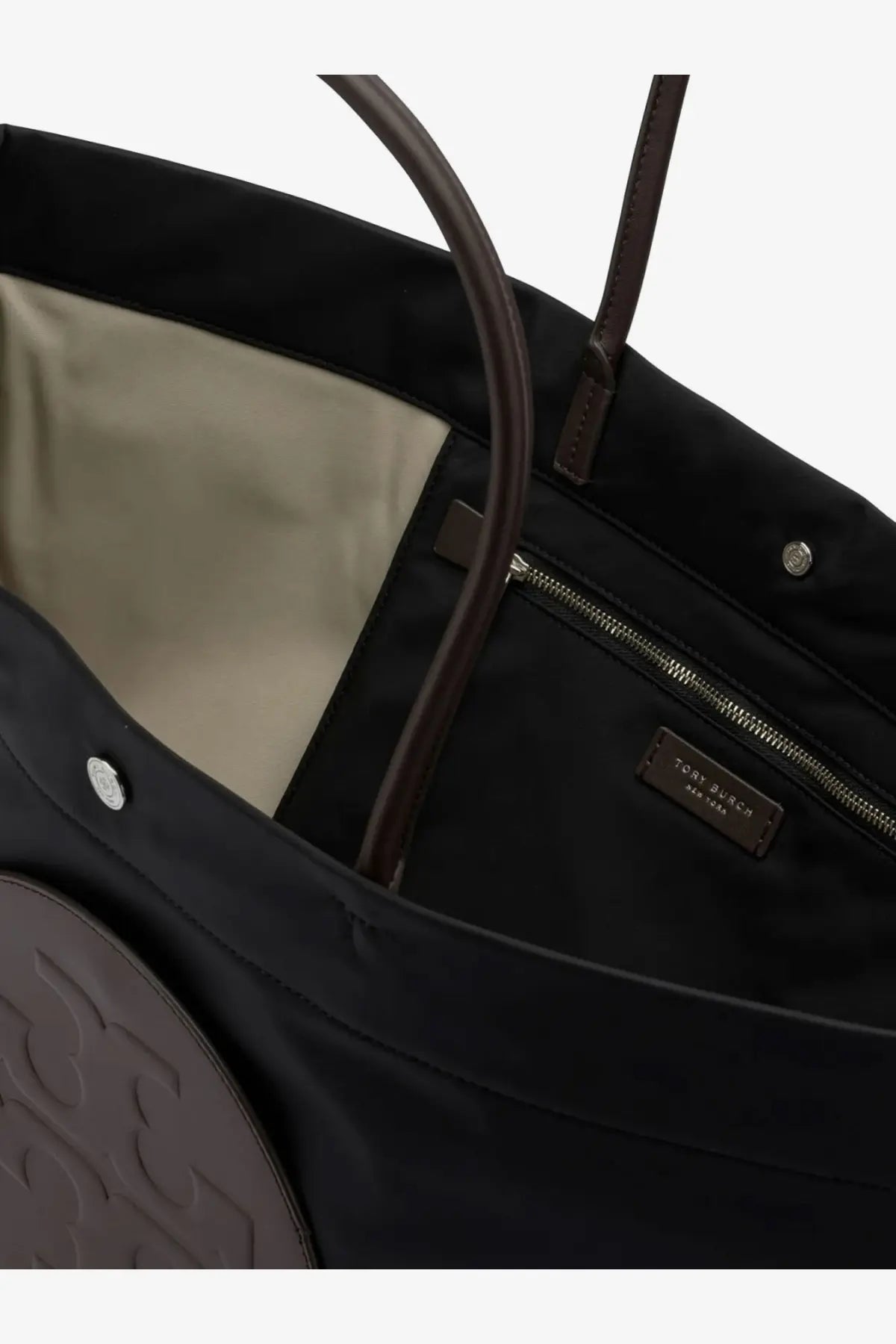 Tory Burch women’s Ella Twist black nylon tote bag with brown leather handles and circular embossed logo on front