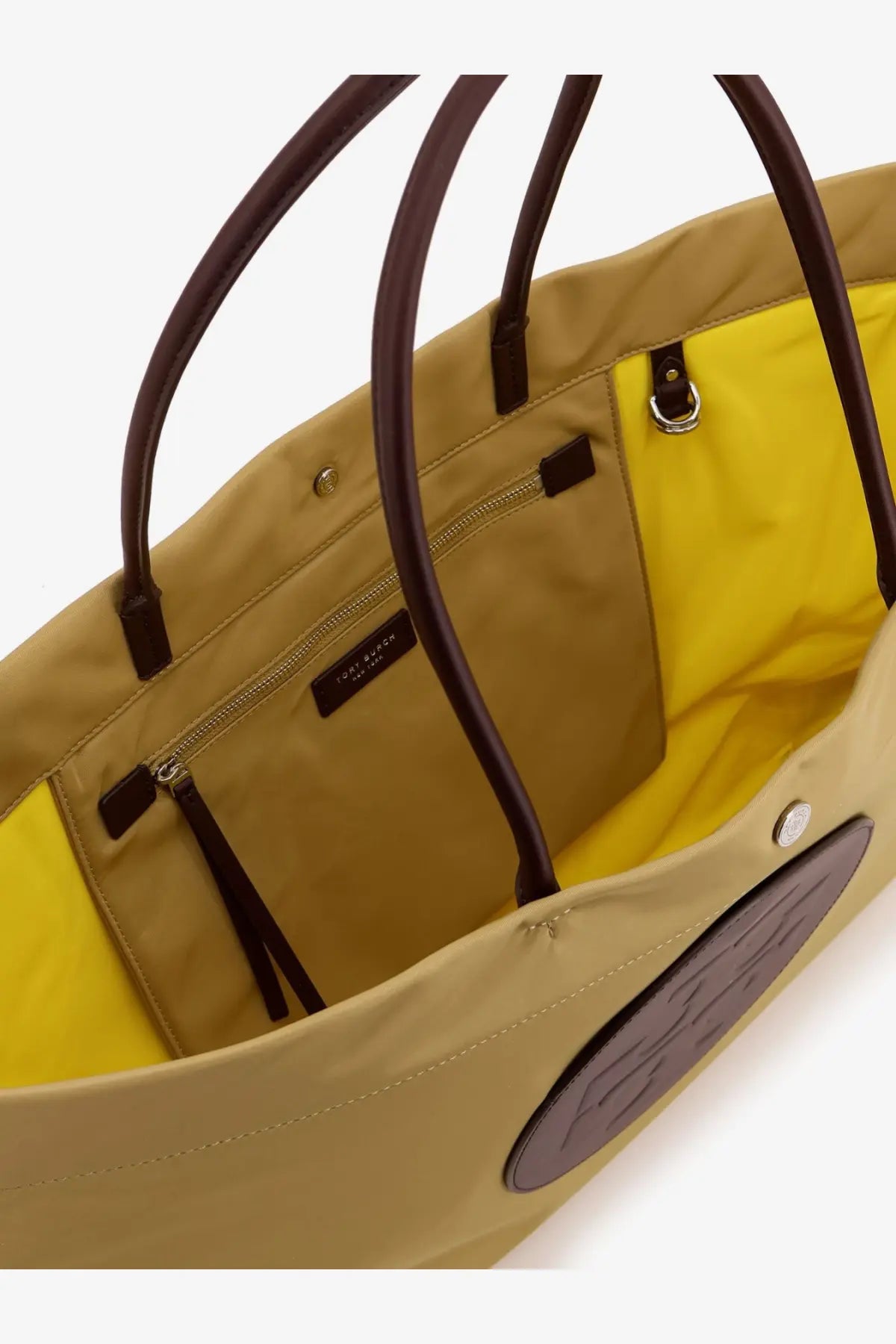 Tory Burch women’s ella twist nylon shoulder bag in wheat with tan canvas, brown leather handles, yellow interior, and embossed logo