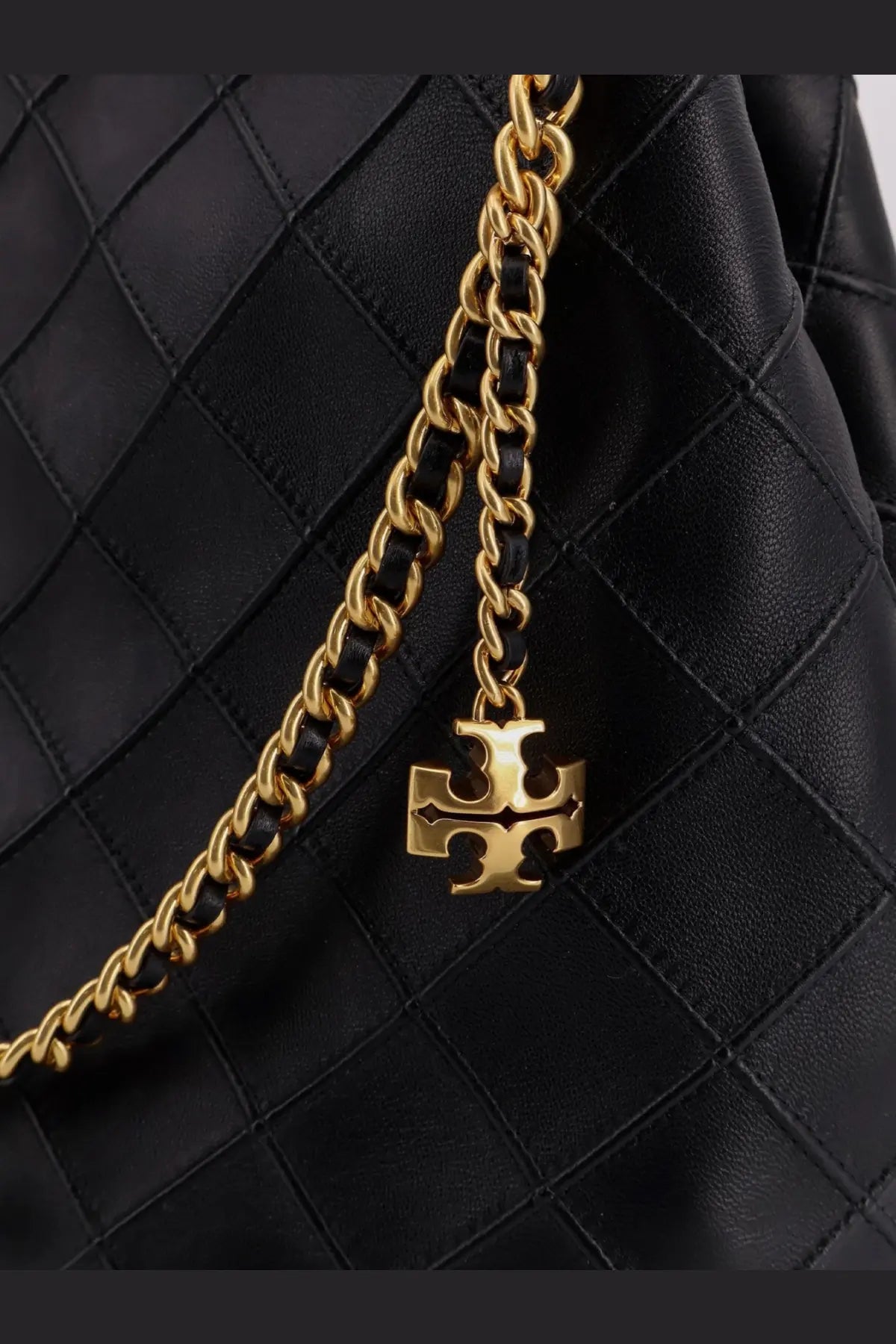 Gold-tone chain with signature tory burch logo charm attached to black quilted leather tory burch womens fleming hobo bag