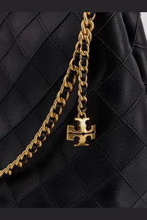 Gold-tone chain with signature tory burch logo charm attached to black quilted leather tory burch womens fleming hobo bag