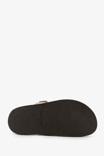 Dark brown rubber sole with subtle texture and toms branding on tory burch womens ines low suede sandals avola