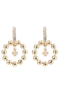 Gold-toned Tory Burch women’s Kira earrings with beaded hoops, crystal posts, and dangling cross charms in white