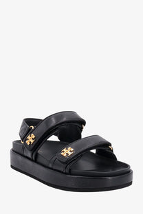 Tory Burch women’s Kira black leather sandals with gold-tone logo accents and platform sole