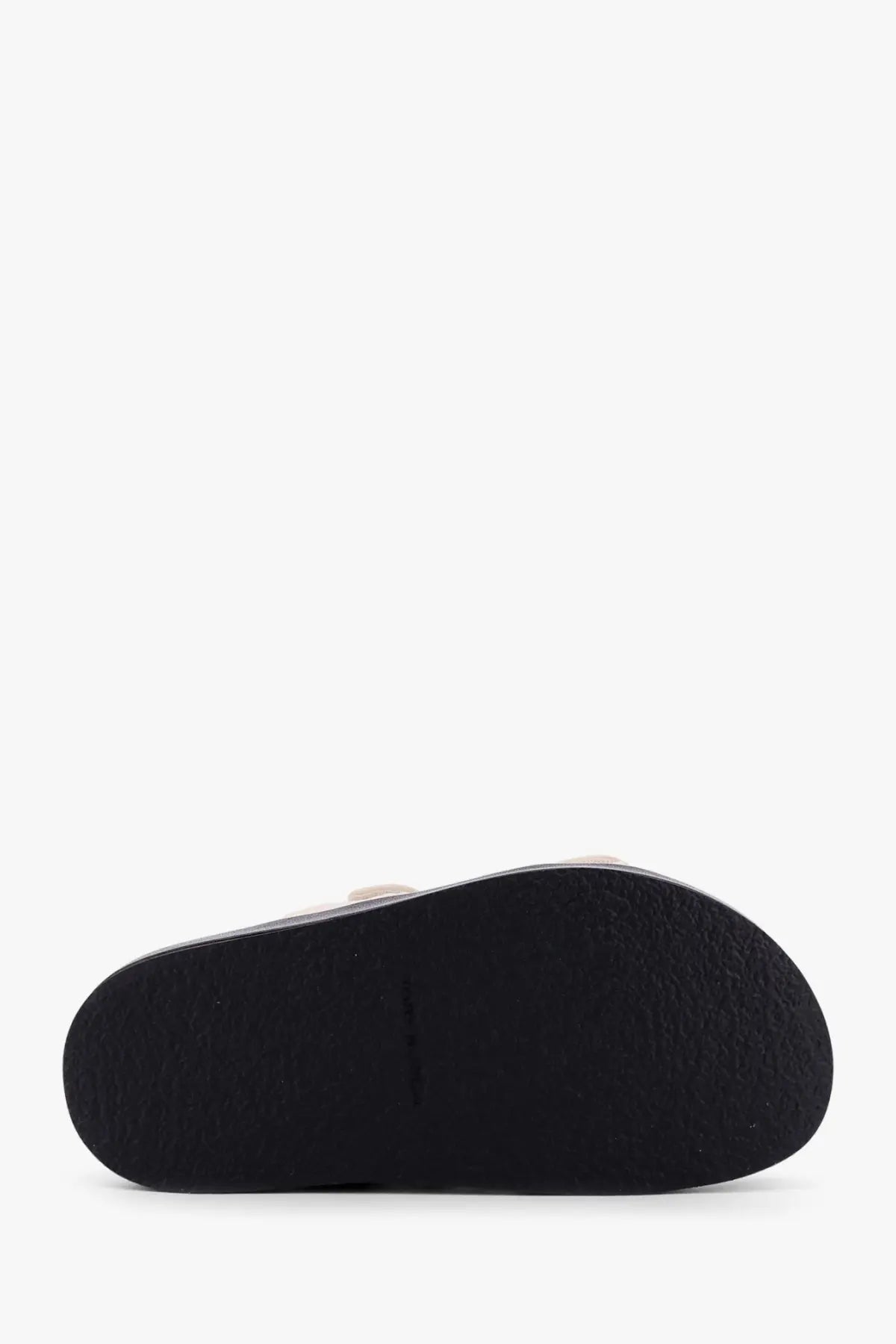 Black rubber sole with textured grip pattern on tory burch women’s kira low leather white sandals