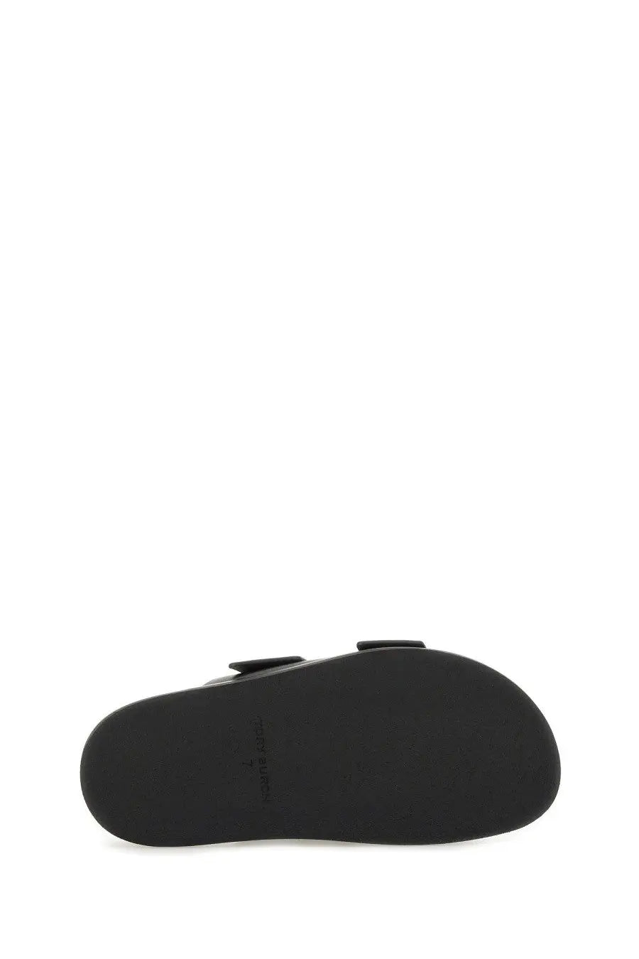 Black rubber sole of tory burch women’s lock sandal featuring minimalist design and subtle branding on the back side