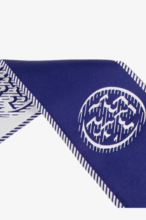 Tory Burch women’s medallion ribbon silk tie blue deep blue silk scarf with bold white geometric circular emblem and striped edge