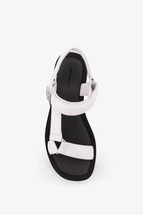 Tory Burch women’s mellow leather wedge sandals in white with black sole and silver-toned buckle detail
