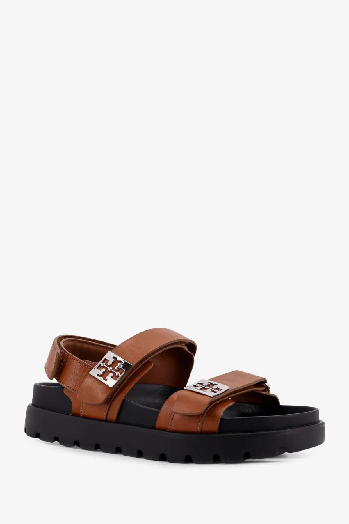 Tory Burch women’s mellow low leather sandals beige with brown leather, black rubber soles, and silver-tone logo buckles