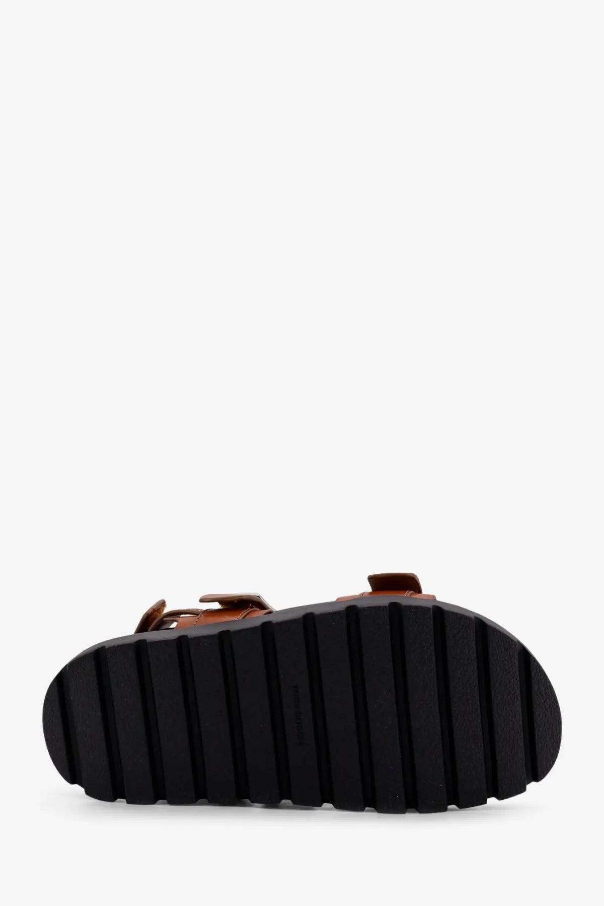 Tory burch women’s mellow low beige leather sandals with black rubber sole featuring vertical grooves
