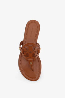 Tan leather Tory Burch thalia thong sandal with a circular logo medallion in Tory Burch women’s Miller leather beige sandal style