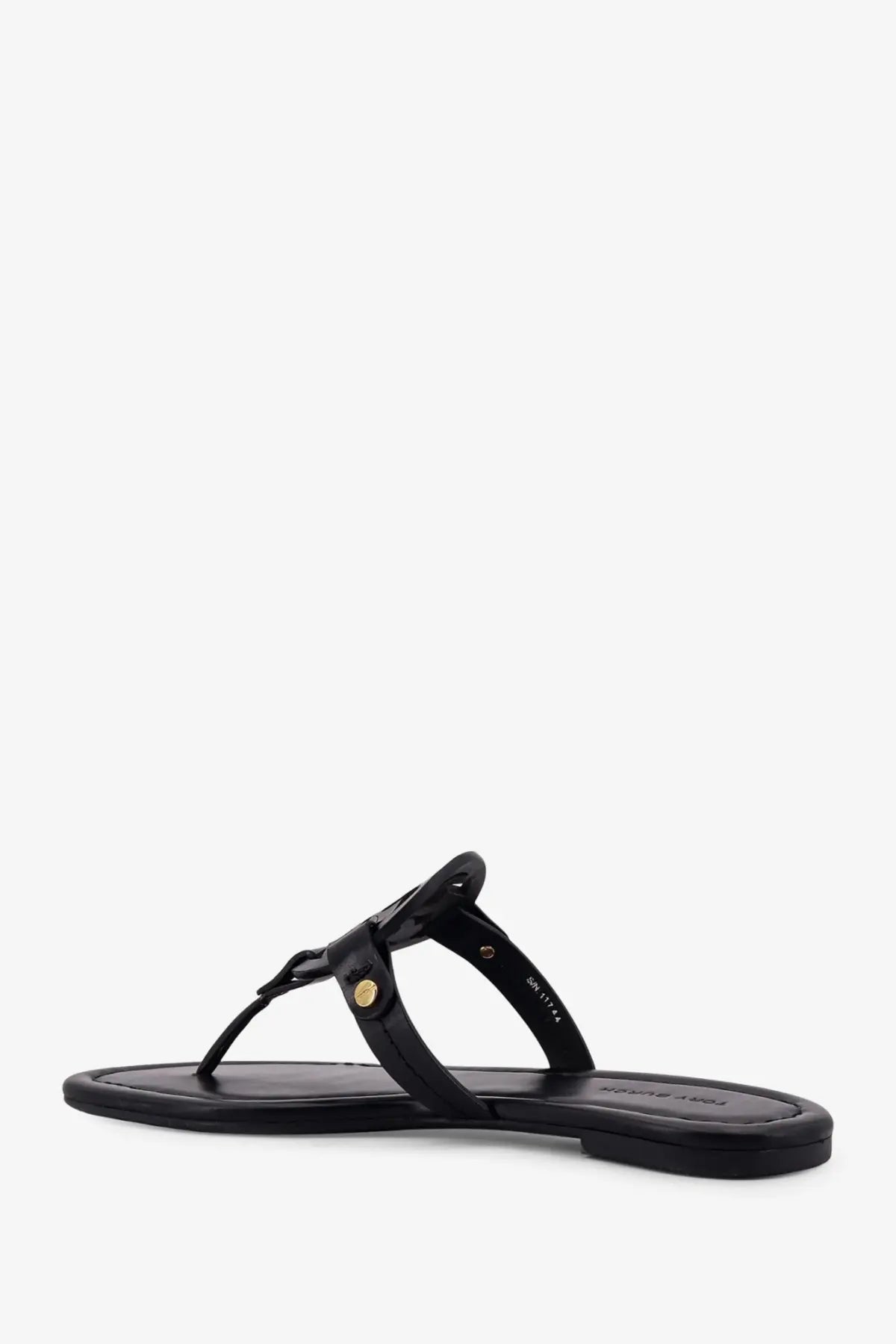 Tory burch women’s miller leather thong sandal in black with gold-tone circular buckle detail