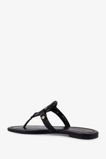 Tory burch women’s miller leather thong sandal in black with gold-tone circular buckle detail