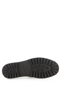 Tory Burch women’s mocassino classico black showing a black rubber sole with rugged textured tread and triangular grip markings