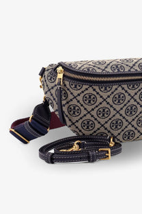 Tory Burch women’s monogram belt bag with beige and navy canvas body, gold hardware, and dark navy leather straps