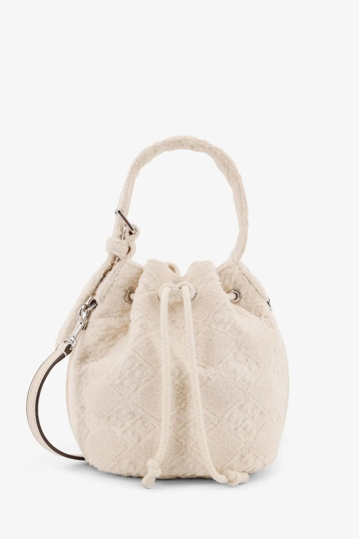 Cream-colored quilted canvas bucket bag with drawstring closure and braided handles by tory burch