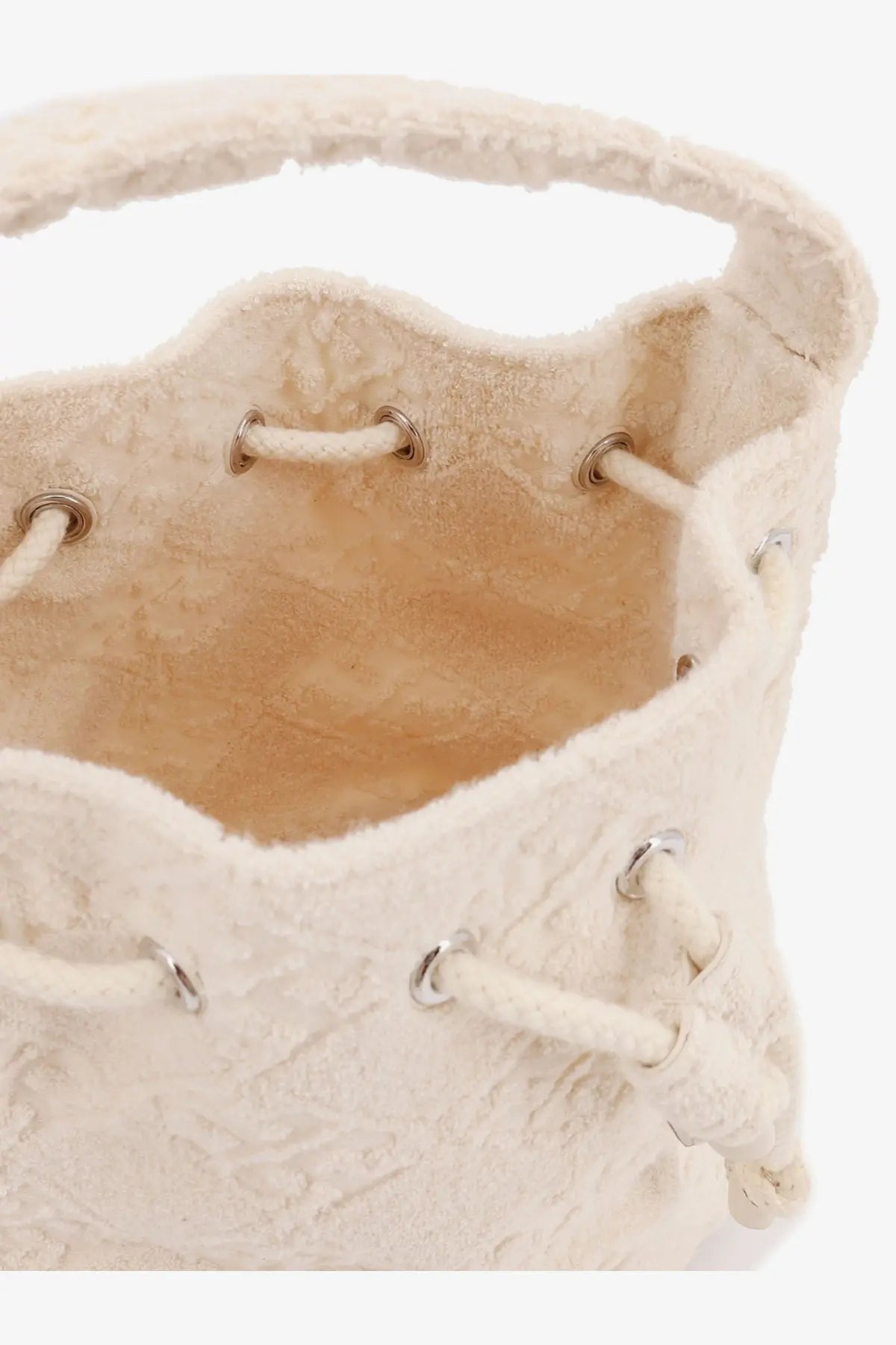 Cream-colored tory burch women’s monogram terry mini canvas bucket bag with textured drawstring closure and metallic eyelets