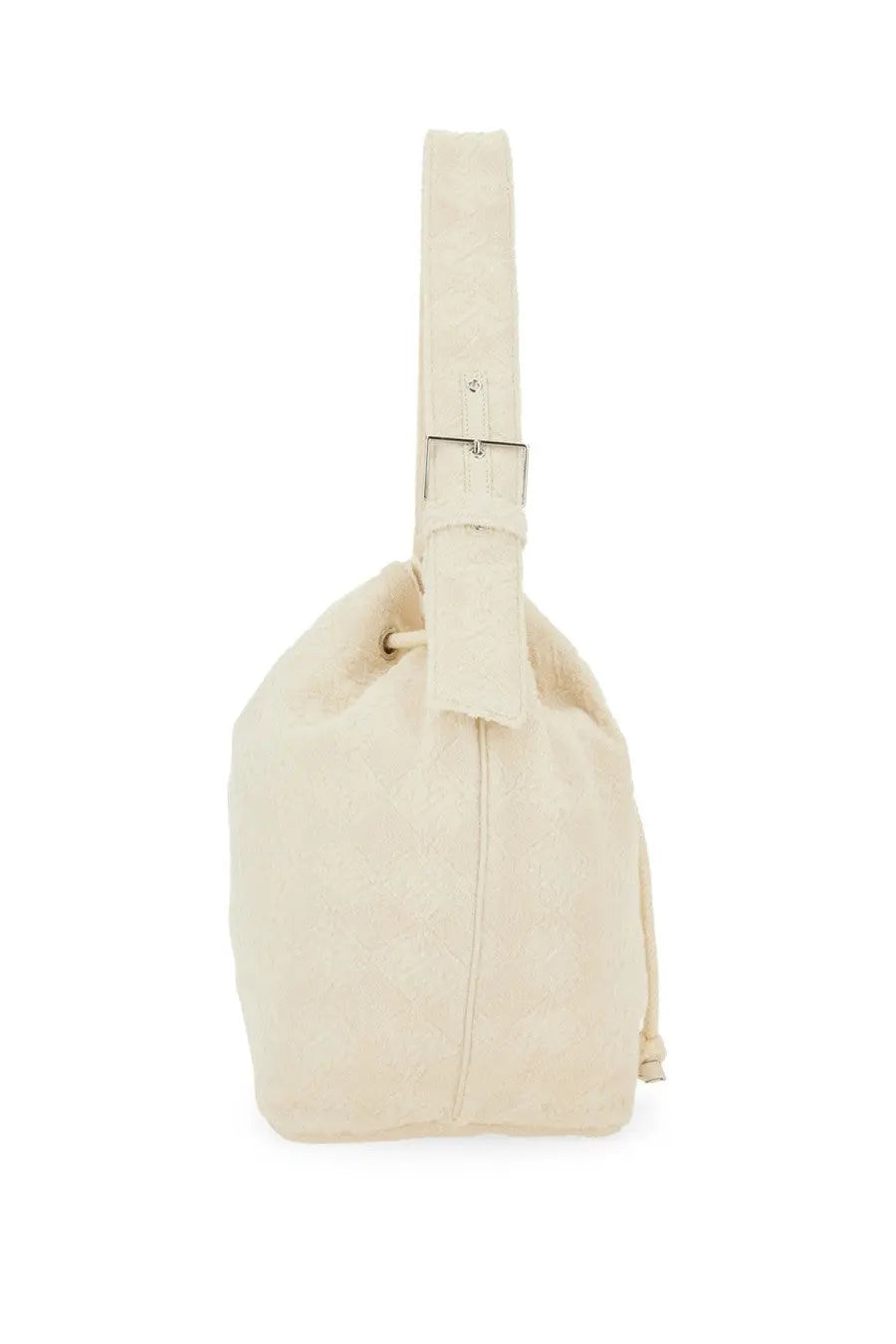 Cream-colored canvas Tory Burch oversized monogram bucket bag with silver-toned buckle and adjustable drawstring strap