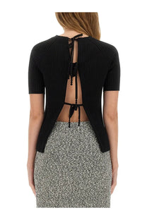 Back view of Tory Burch women’s black ribbed cotton short-sleeve pullover with tie detail at the back