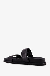 Tory burch women’s romy black leather slide sandal with two straps and flat cushioned sole visible from front