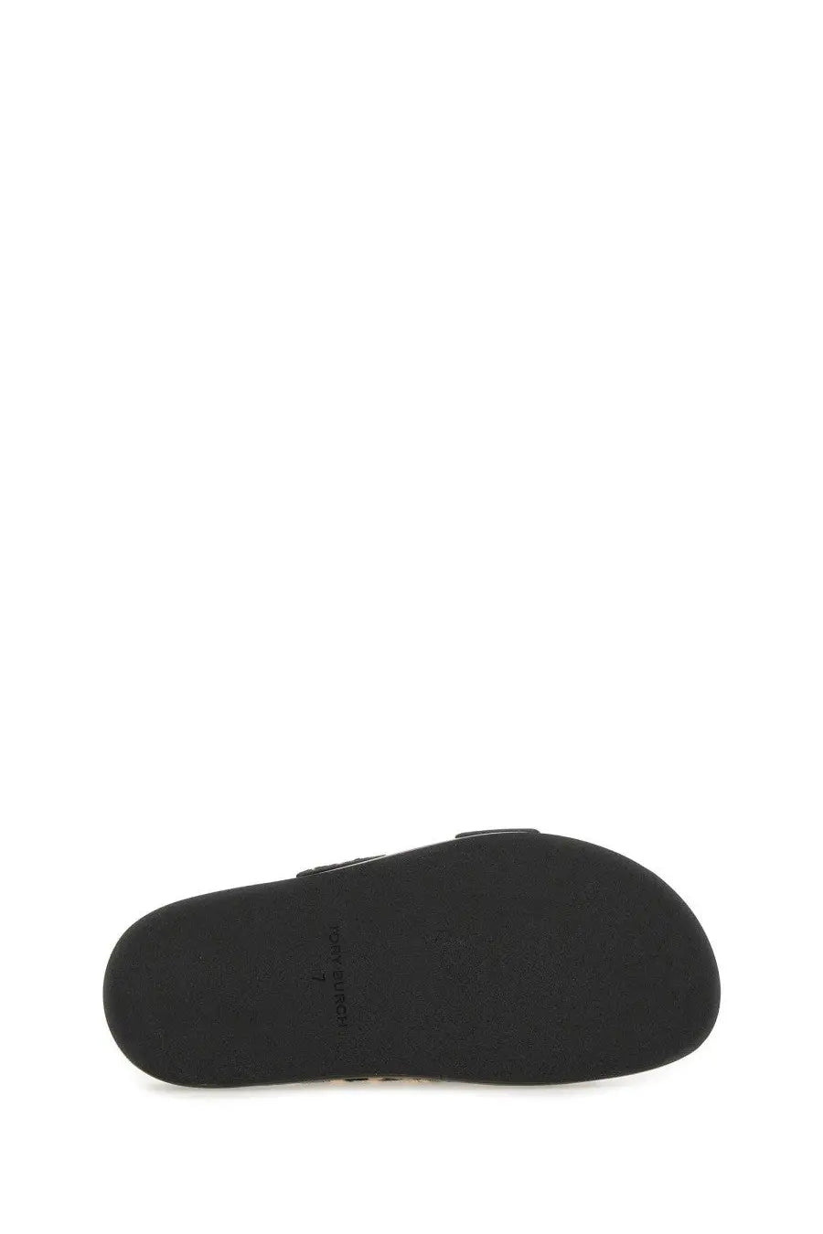 Black rubber sole with minimalist design and subtle branding on Tory Burch women’s sandal lock black