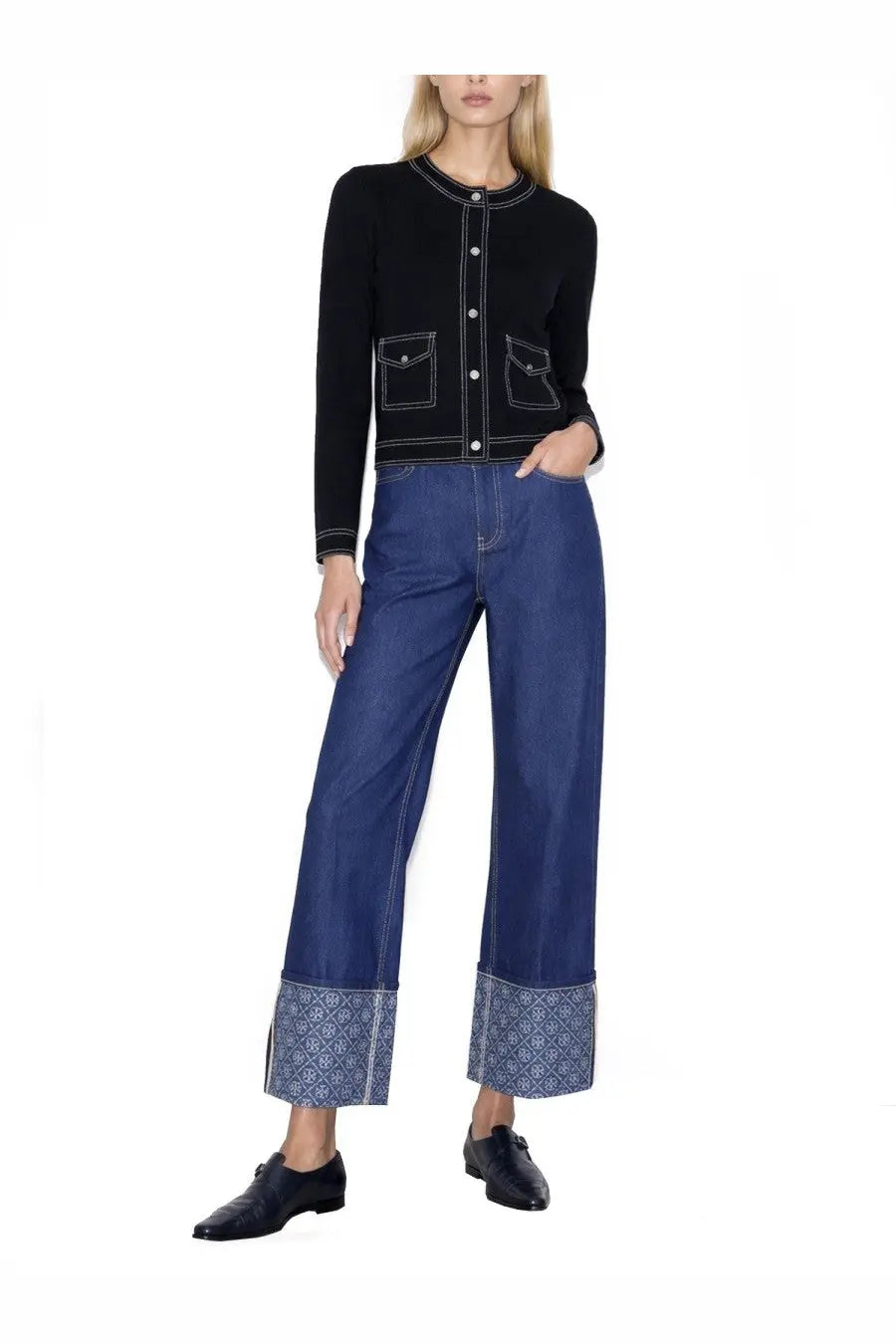 Tory Burch women’s topstitched black cardigan with white stitching and front pockets paired with wide-leg denim pants
