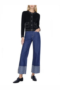 Tory Burch women’s topstitched black cardigan with white stitching and front pockets paired with wide-leg denim pants