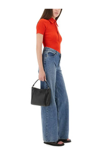 Black leather handbag with top handle and small logo displayed alongside tory burch womens red viscose polo shirt