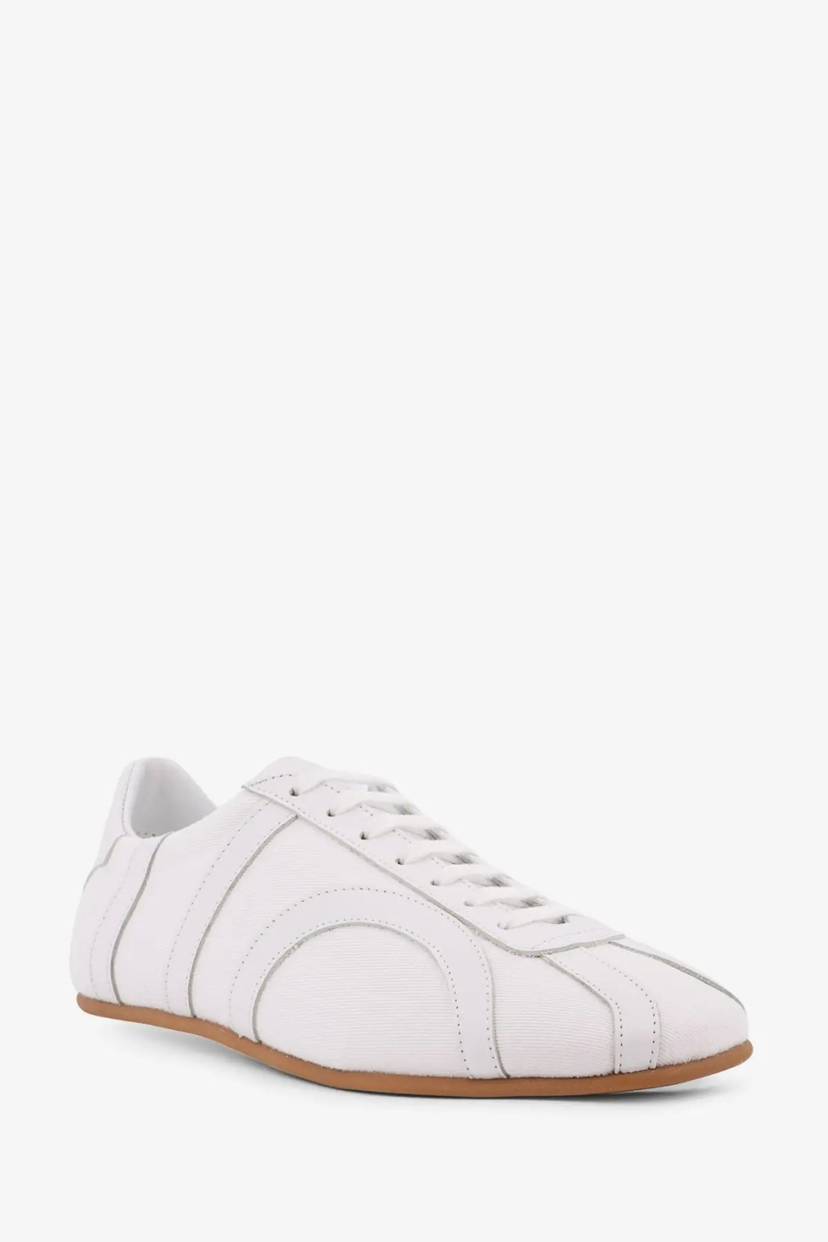 Toteme women’s canvas low top sneakers in white leather with subtle stitched paneling and tan rubber sole
