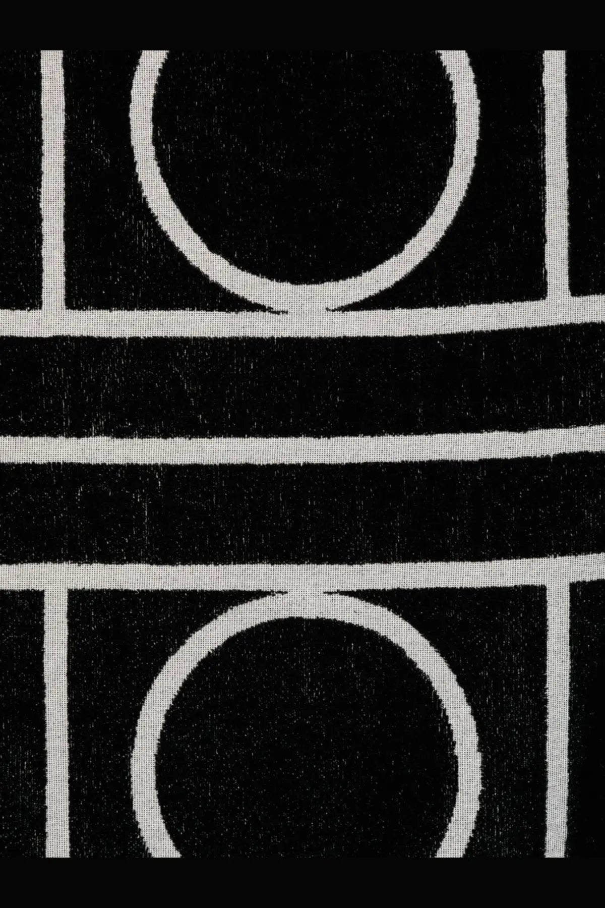 Toteme women’s cotton beach towel in black with bold circular black and white geometric pattern