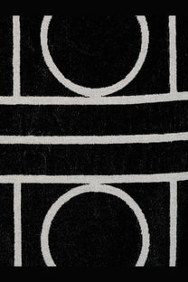 Toteme women’s cotton beach towel in black with bold circular black and white geometric pattern