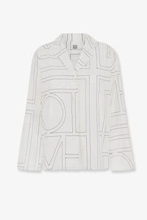 Toteme women’s cotton blend pajama top in white with black geometric line pattern long sleeves and collar