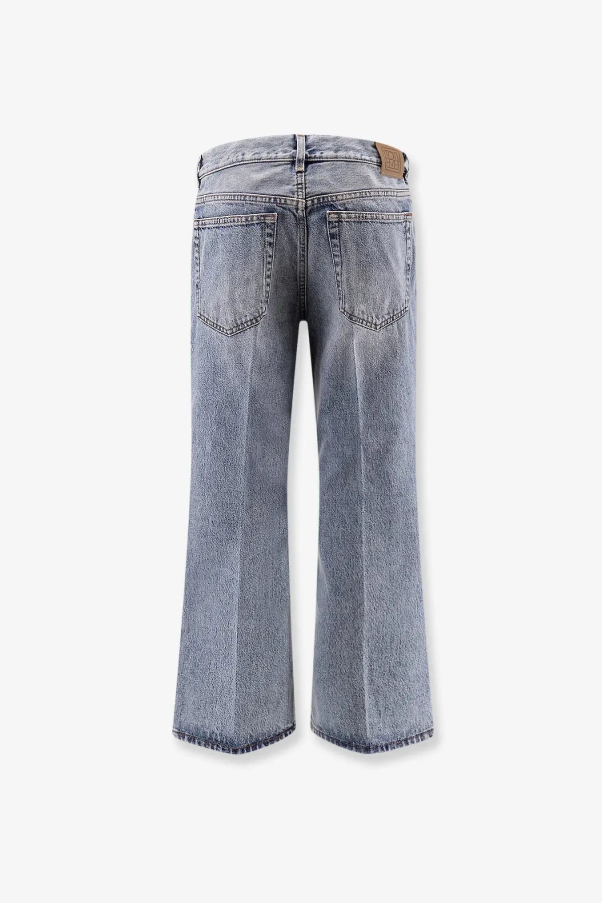 Toteme women’s cotton jeans in grey with light-wash wide-leg cut and frayed hems visible from the back side