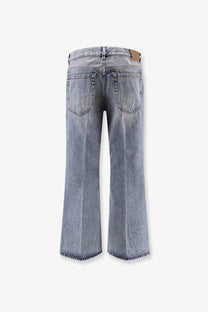 Toteme women’s cotton jeans in grey with light-wash wide-leg cut and frayed hems visible from the back side