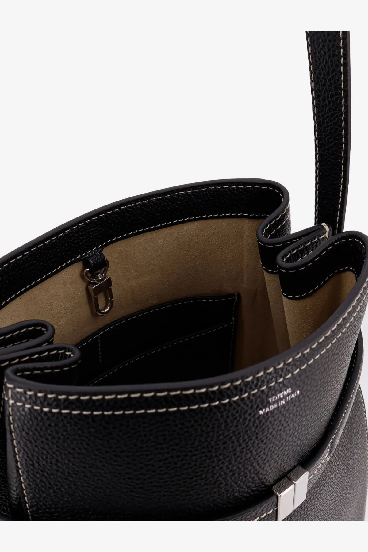 Toteme women’s hammered leather bucket bag in black with black pebbled leather, white stitching, and silver-tone clasp