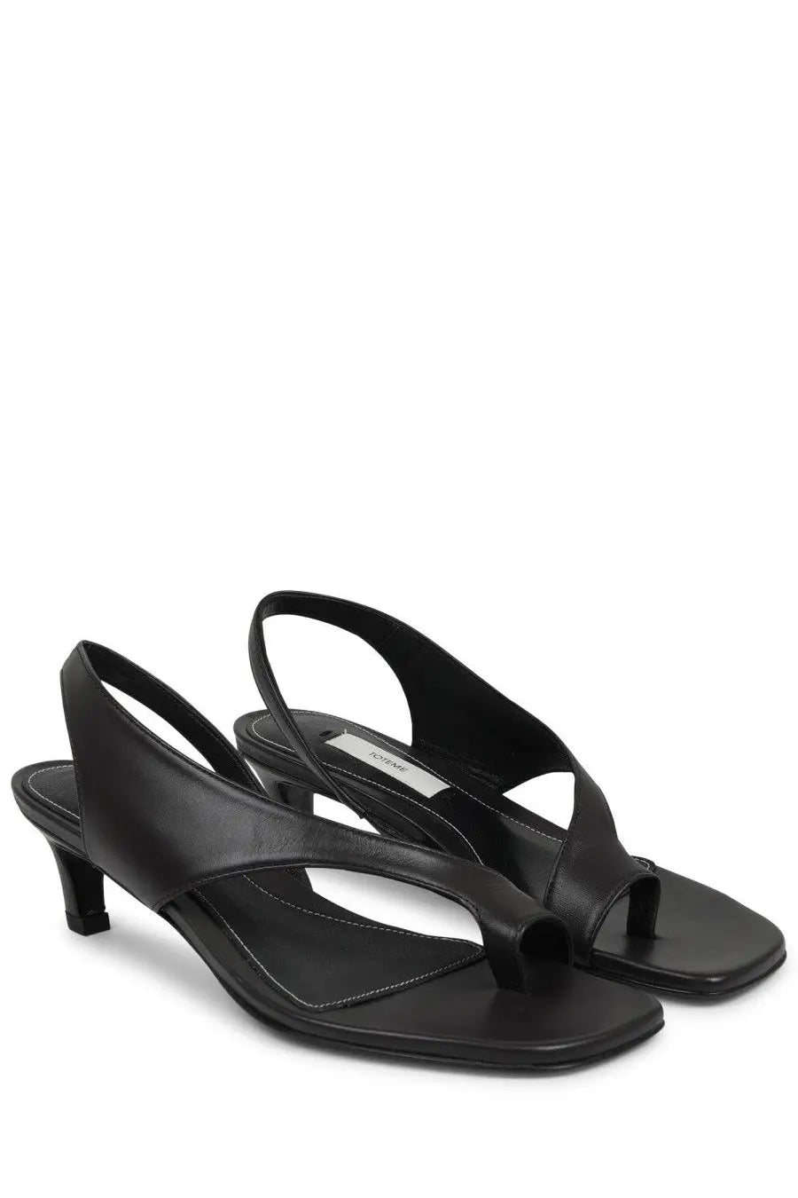 Toteme women’s black leather heeled sandal with minimalist design and low heel shown from the back side